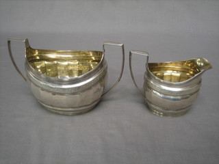 A George III twin handled silver sugar bowl, London 1803 together with a with matching cream jug, London 1804 12 ozs