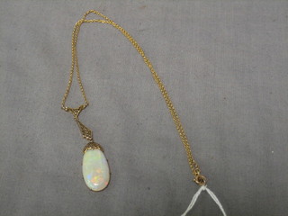 A gold chain hung an opal pendant
