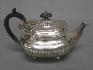 A Victorian silver plated Bachelor's teapot of oval form with demi-reeded decoration raised on 4 bun feet