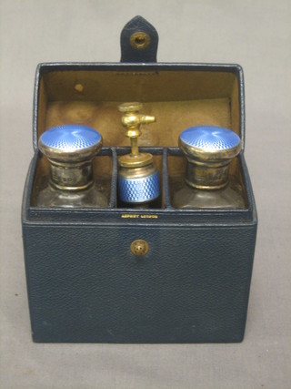 2 cut glass perfume bottles with blue enamelled lids, a perfume atomiser (f) London 1932 contained in a green leather finished case marked Asprey's
