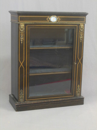 A Victorian ebonised Pier cabinet with Wedgwood plaque and gilt metal mounts, the interior fitted adjustable shelves enclosed by a glazed panelled door 30"