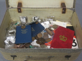 A collection of various coins contained in a small attache case