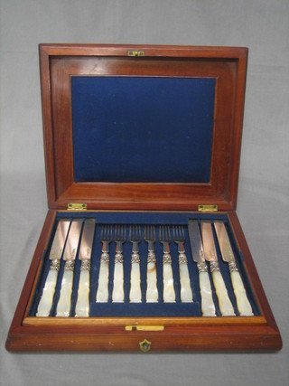 A set of 12 Victorian silver bladed fruit knives and forks with mother of pearl handles, Birmingham 1854 contained in a mahogany canteen box (1 fork handle f)