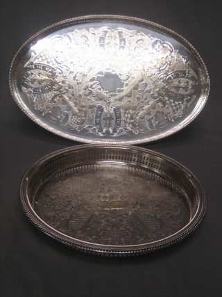 A circular silver plated galleried tea tray and an oval ditto