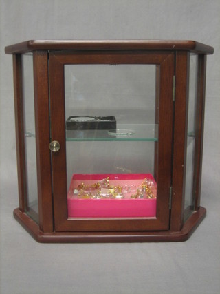 16 various Swarovski items contained in a glazed display cabinet
