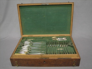 A part canteen of silver plated Old English flatware contained in an oak canteen box