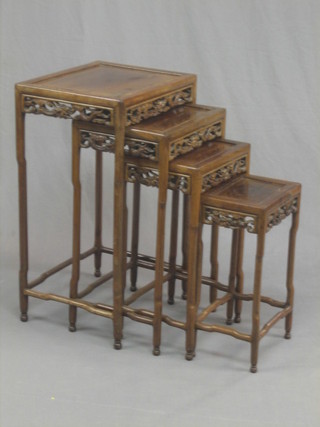 A nest of 4 rectangular pierced Padouk wood interfitting coffee tables