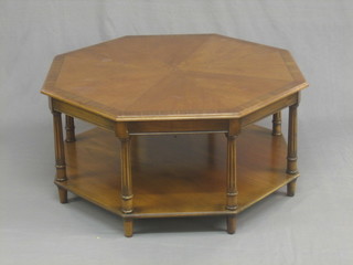 A Georgian style octagonal mahogany coffee table with crossbanded top, raised on turned and fluted supports with undertier 36"