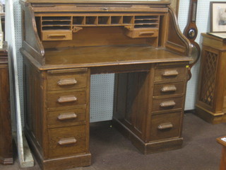 A Victorian oak kneehole pedestal roll top desk with tambour shutter 48" (requires some attention)