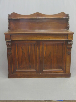 A William IV rosewood chiffonier with raised back fitted a drawer above a double cupboard, raised on a platform base 51"
