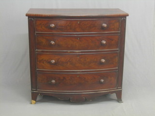 A Victorian mahogany bow front chest of 4 long drawers with tore handles, raised on bracket feet 43"