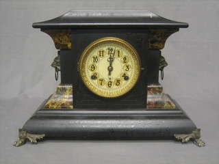 An American 8 day mantel clock contained in a wooden architectural style case with paper dial and Arabic numerals