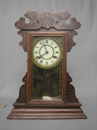 An American shelf clock with paper dial and Roman numerals contained in a walnut finished case
