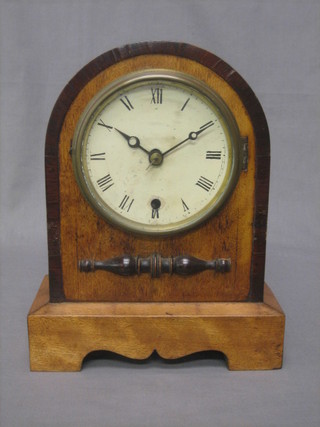A 19th Century mahogany mantel clock with paper dial and Roman numerals contained in a wooden arch shaped case