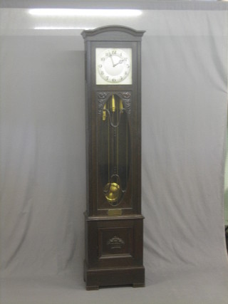 A 1930's chiming longcase clock with 12" square silvered dial and Arabic numerals, contained in an oak case 84"