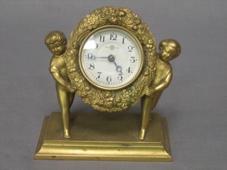A bedroom timepiece with silvered dial and Arabic numerals contained in a gilt metal case supported by 2 figures of cherubs