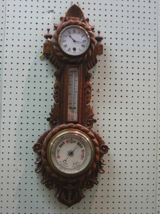 A Victorian aneroid barometer with enamelled dial contained in a carved oak case surmounted by a clock