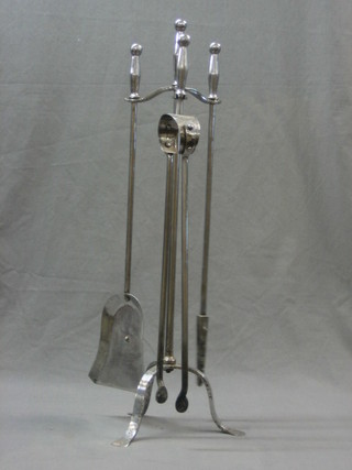 A polished steel 3 piece fireside companion set comprising tongs, poker and shovel