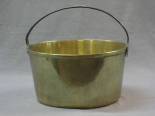 A brass preserving pan with iron handle