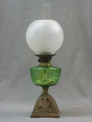 A Victorian green glass oil lamp reservoir raised on a pierced gilt metal base