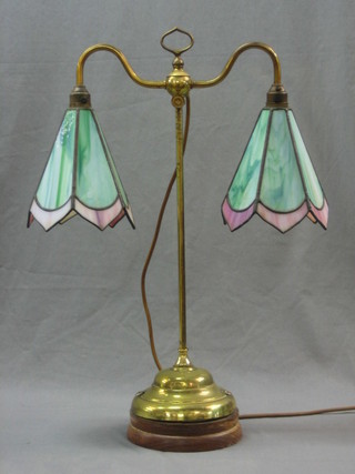 A brass twin light table lamp with green leaded light shades