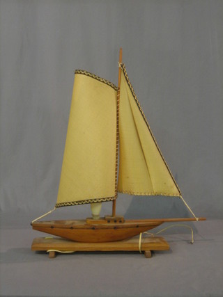 An Art Deco teak table lamp in the form of a yacht 17"