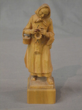 A Continental carved wooden figure of a standing lady, knitting 7"