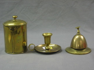 A brass bell, a brass chamber stick and a cylindrical tea caddy  and with spoon