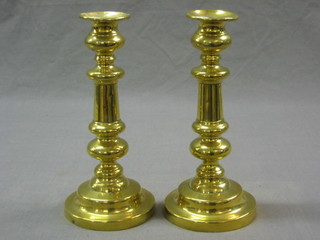 A pair of 19th Century brass candlesticks with ejectors 8 1/2"