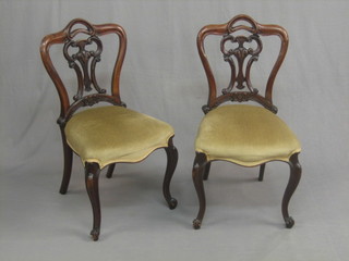 A set of 6 Victorian mahogany stylised balloon back dining chairs with vase shaped slat backs, the seats of serpentine outline, raised on cabriole supports