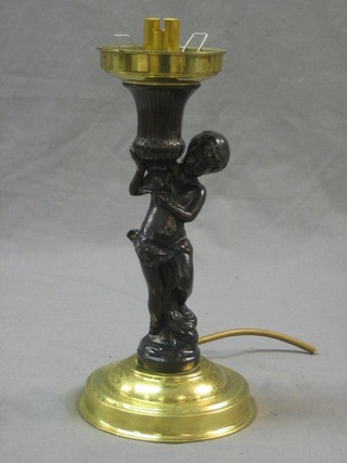 A bronzed table lamp in the form of a standing cherub 10"