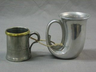 A Victorian half pint pewter measure and an American pewter mug