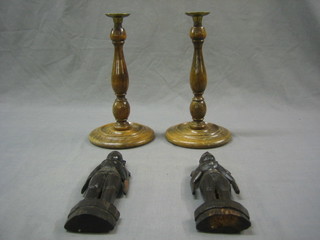 A pair of turned wooden candlesticks 11" and a pair of carved wooden figures 9"