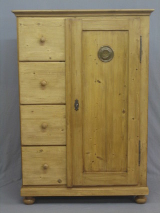 A Continental stripped and polished pine combination wardrobe with enclosed panelled door, the side fitted 4 drawers 38"