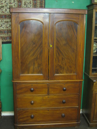 A Victorian mahogany linen press, the upper section with moulded cornice the interior fitted 4 trays, the base fitted 2 short drawers above 2 long drawers 47"