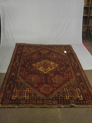 A Persian red ground rug with all-over geometric design 93" x 62"