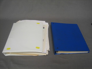 A blue plastic loose leaf stamp album and a white ditto