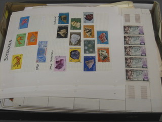 A shallow cardboard tray containing a collection of various stamps etc