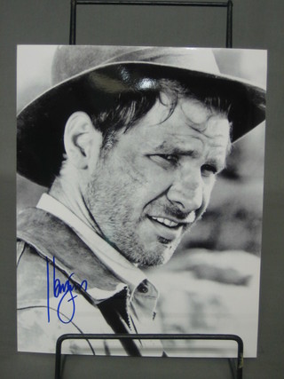A signed black and white photograph of Harrison Ford as Indiana Jones 10" x 8 1/2"