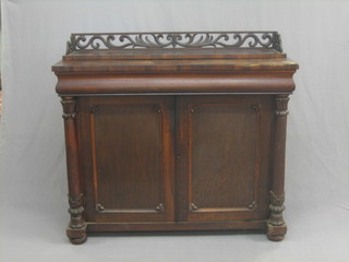 A William IV rosewood chiffonier with raised back and pierced three-quarter gallery, the base fitted a drawer above a double cupboard flanked by a pair of turned columns 47"