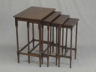 A quartetto of mahogany interfitting coffee tables, raised on turned and block supports 19"