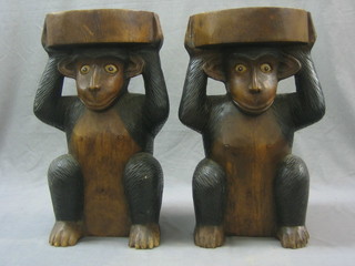 A pair of carved Eastern stools in the form of seated monkeys