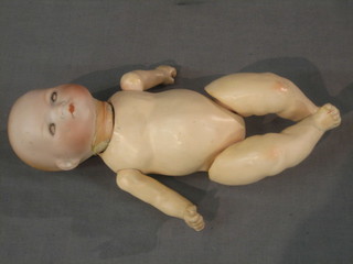 A 19th Century porcelain doll with opening and shutting eyes and open mouth (crack to head)