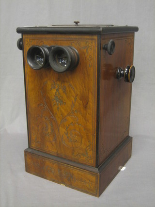 A Victorian table top stereoscopic viewer contained in a carved walnut case