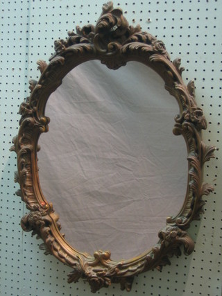 A plate mirror contained in a decorative gilt plaster frame 27"