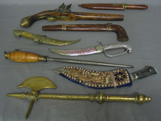 A reproduction flint lock pistol, 4 various Eastern daggers, a Kukri, a steel and a small brass axe