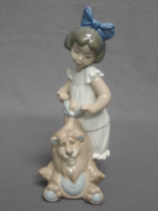 A Nao figure of a standing girl with cuddly lion 9"