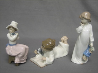 A Nao figure of a seated boy reading a book with puppy 8", 1 other in the form of a standing girl with dolls 8" and a seated girl with puppy 6 1/2" (3)