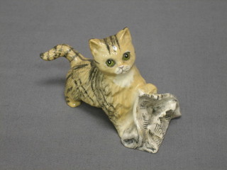 A Royal Doulton figure of a kitten with newspaper (chips to ears)