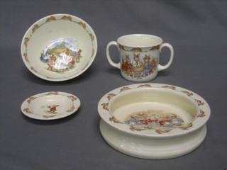 A 1954 circular Doulton Bunnykins bowl, a Bunnykins dish, butter dish (chip to rim) and a 1984 twin handled mug